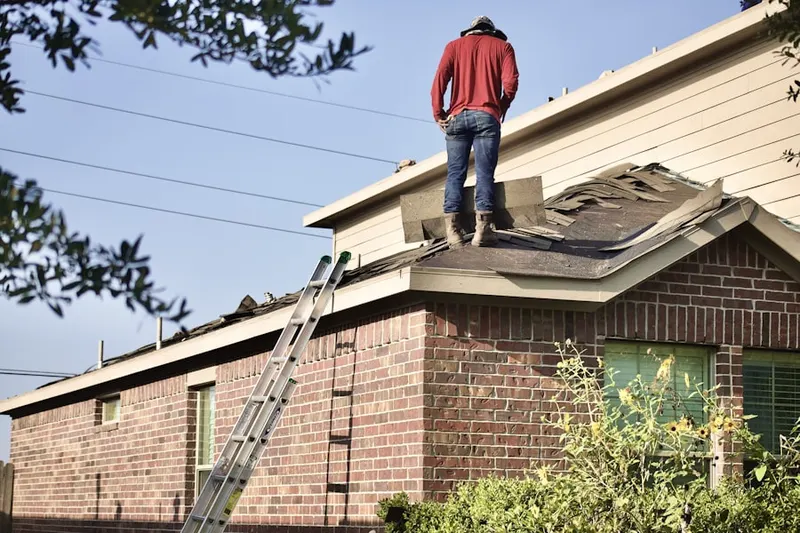 Professional roofer working on a residential roof in Colemans Mill Crossing